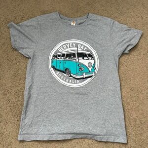 Vintage gray t-shirt featuring a graphic of a turquoise Volkswagen van